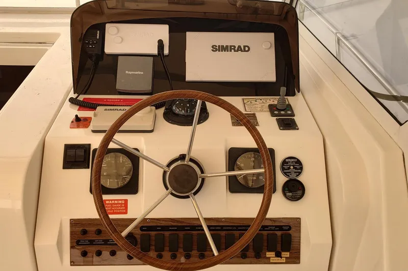 Slide: The Image of 2003 Mainship 34 PILOT helm with Simrad navigation and wooden steering wheel. - 39