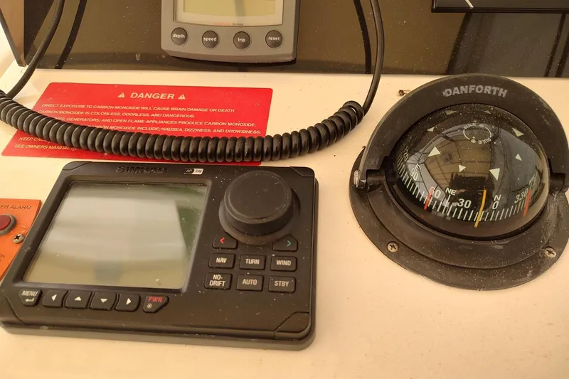 Slide: The Image of Control panel of a 2003 Mainship 34 PILOT with compass and navigation system. - 41