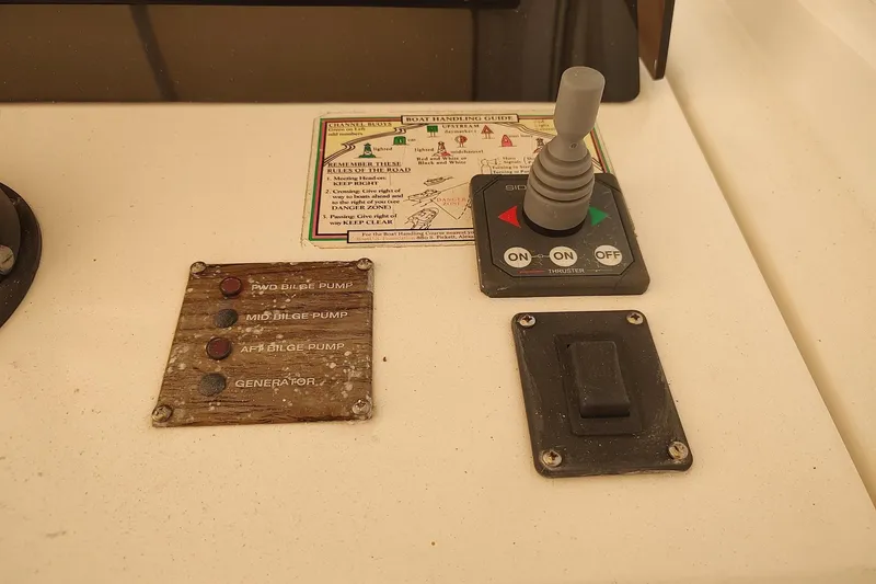 Slide: The Image of Control panel of a 2003 Mainship 34 PILOT boat with bilge pump switches. - 42