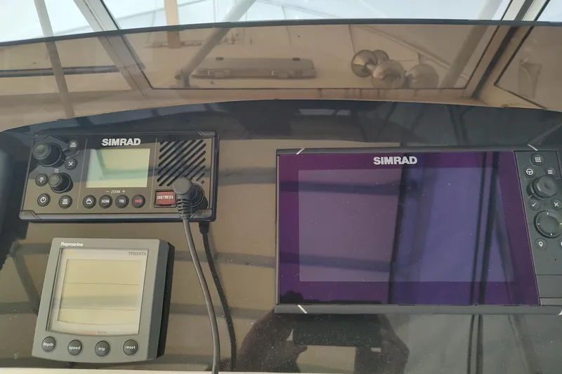 Slide: The Image of Control panel of a 2003 Mainship 34 PILOT with Simrad and Raymarine electronics. - 45