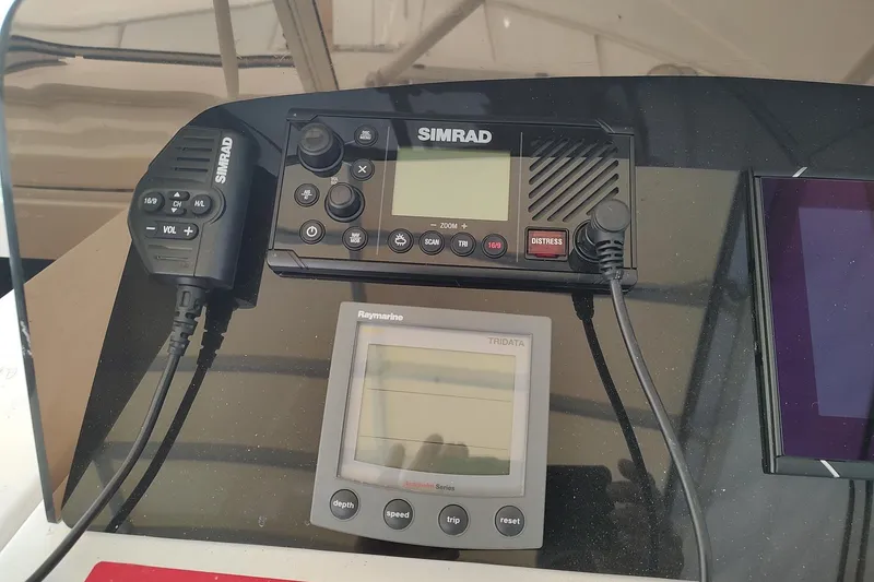 Slide: The Image of Simrad and Raymarine navigation equipment on 2003 Mainship 34 Pilot boat dashboard. - 46