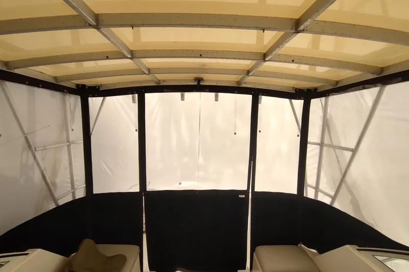 Slide: The Image of 2003 Mainship 34 PILOT boat interior with canopy and seating area. - 48