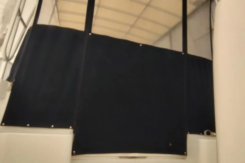 Slide: The Image of 2003 Mainship 34 PILOT boat interior with dark canvas enclosure. - 49