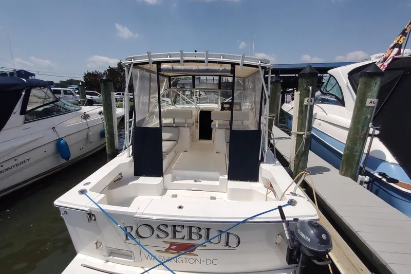 Slide: The Image of 2003 Mainship 34 PILOT boat docked, rear view with canopy and seating area. - 5