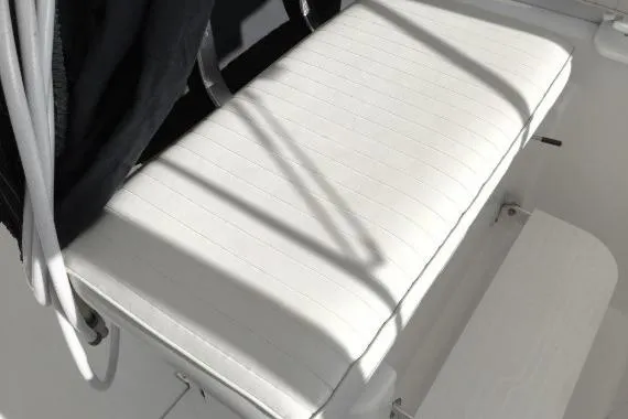 Slide: The Image of White cushioned seat on 2003 Mainship 34 PILOT boat, with sunlight casting shadows. - 54