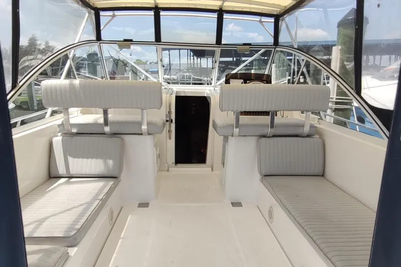 Slide: The Image of 2003 Mainship 34 PILOT boat interior with seating and helm, featuring a spacious cockpit. - 56