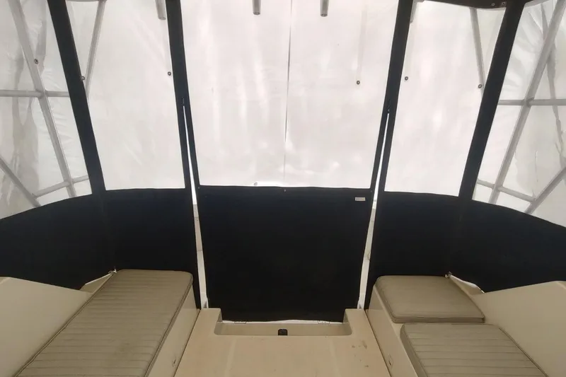 Slide: The Image of Interior view of 2003 Mainship 34 PILOT boat with cushioned seating and protective canopy. - 57