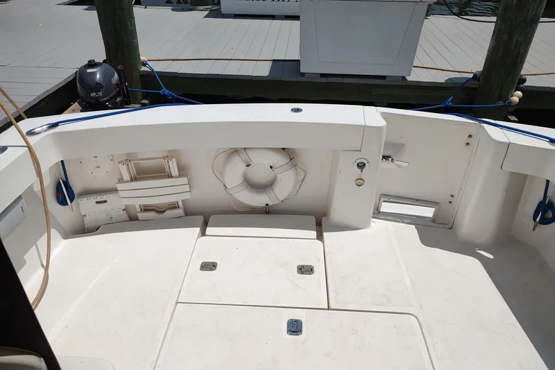 Slide: The Image of 2003 Mainship 34 PILOT boat deck with life preserver and storage compartments. - 58