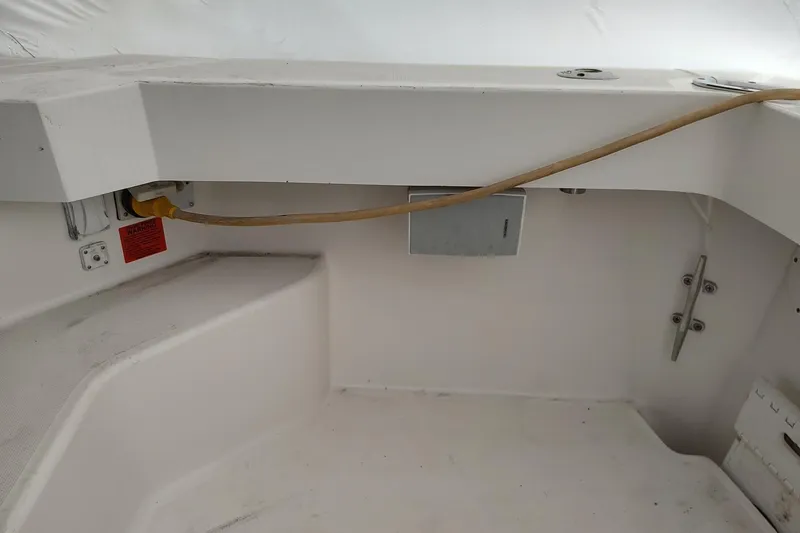 Slide: The Image of 2003 Mainship 34 PILOT boat interior with electrical connections and seating area. - 59