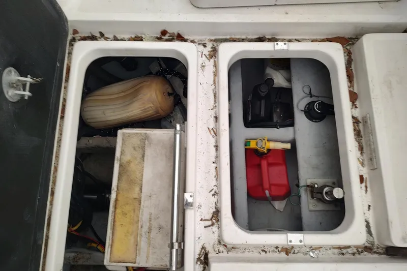 Slide: The Image of Storage compartments on a 2003 Mainship 34 PILOT boat, containing equipment and supplies. - 62