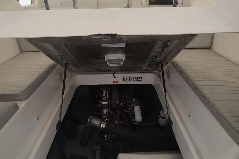 Slide: The Image of 2003 Mainship 34 PILOT engine compartment with open hatch and visible engine components. - 63