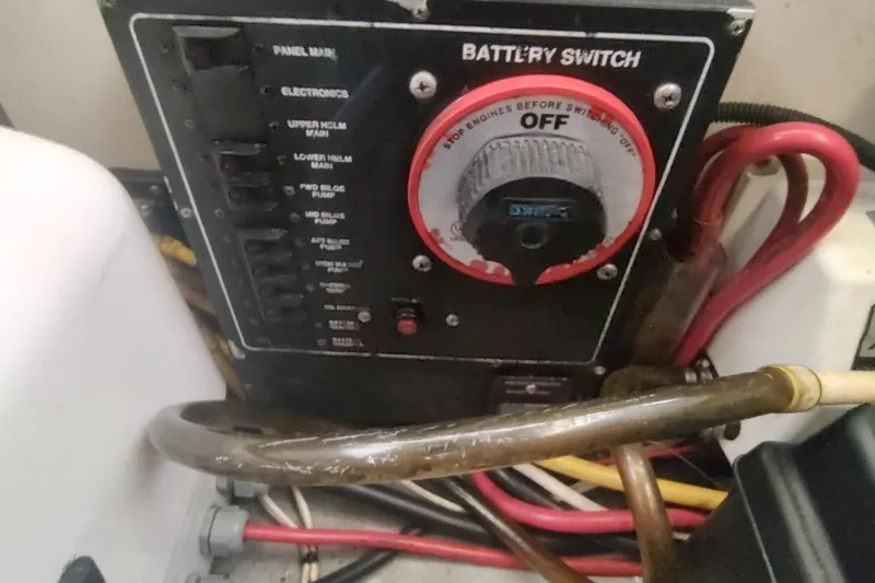 Slide: The Image of Battery switch panel on a 2003 Mainship 34 PILOT boat with wiring connections. - 65