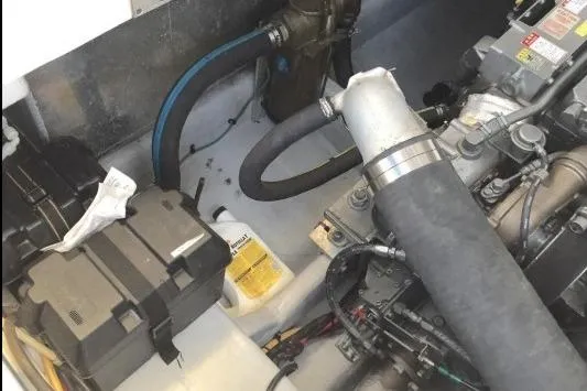 Slide: The Image of Engine compartment of a 2003 Mainship 34 PILOT boat, showing hoses and components. - 69
