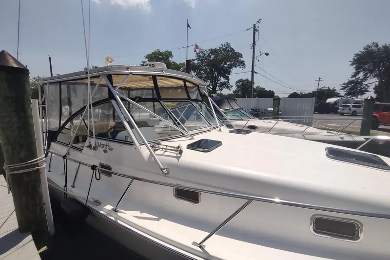 Slide: The Image of 2003 Mainship 34 PILOT boat docked at marina under clear sky. - 7
