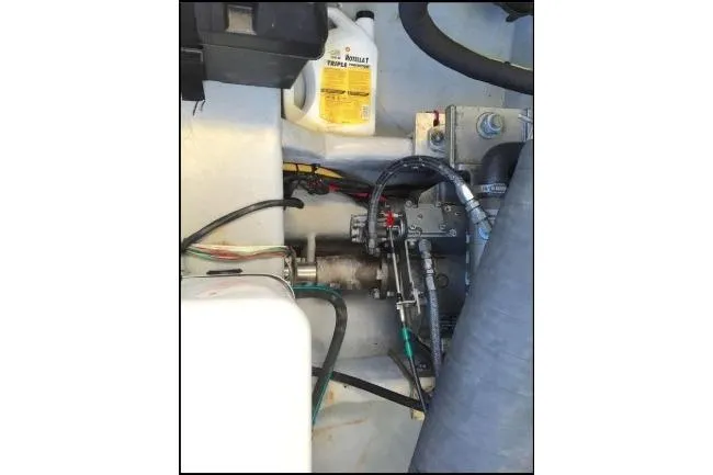 Slide: The Image of Engine compartment of a 2003 Mainship 34 PILOT with visible mechanical components. - 70