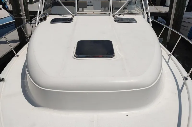 Slide: The Image of 2003 Mainship 34 PILOT boat deck with hatch and railing in marina. - 8