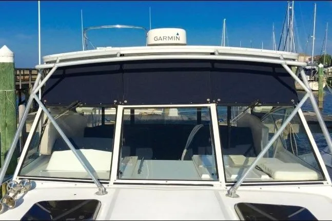 Slide: The Image of 2003 Mainship 34 PILOT boat with Garmin equipment, docked at a marina. - 9