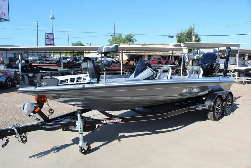 Slide: The Image of 2026 Phoenix 921 ELITE fishing boat on trailer in outdoor dealership lot. - 11