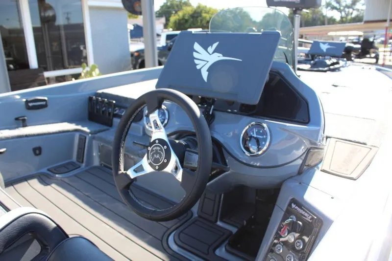 Slide: The Image of 2026 Phoenix 921 ELITE boat dashboard with steering wheel and control panel. - 12