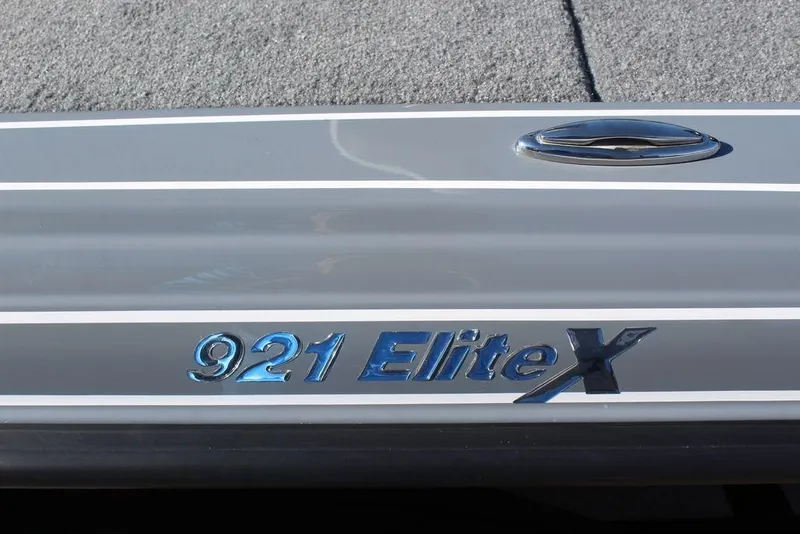 Slide: The Image of Phoenix 921 Elite X emblem on a sleek gray surface, 2026 model. - 15