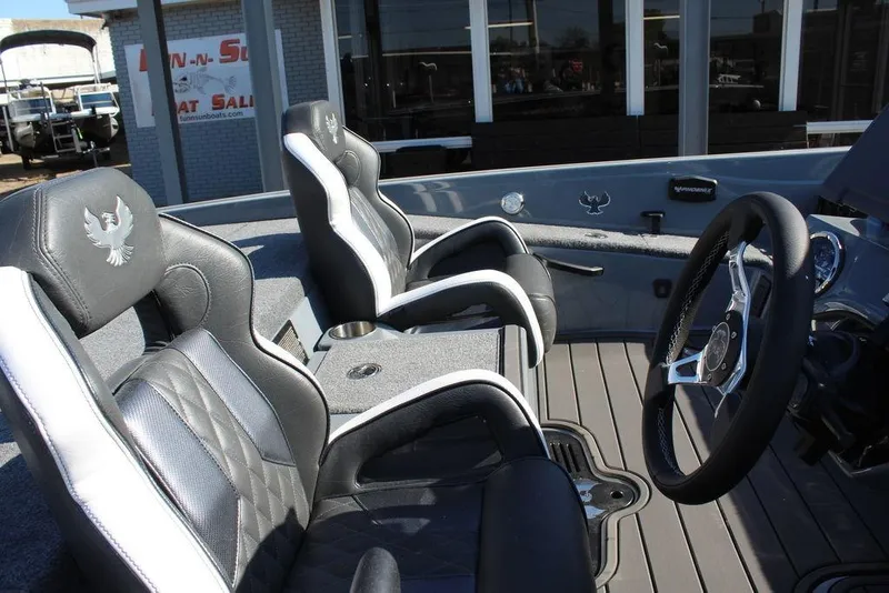Slide: The Image of 2026 Phoenix 921 ELITE boat interior with steering wheel and cushioned seats. - 17