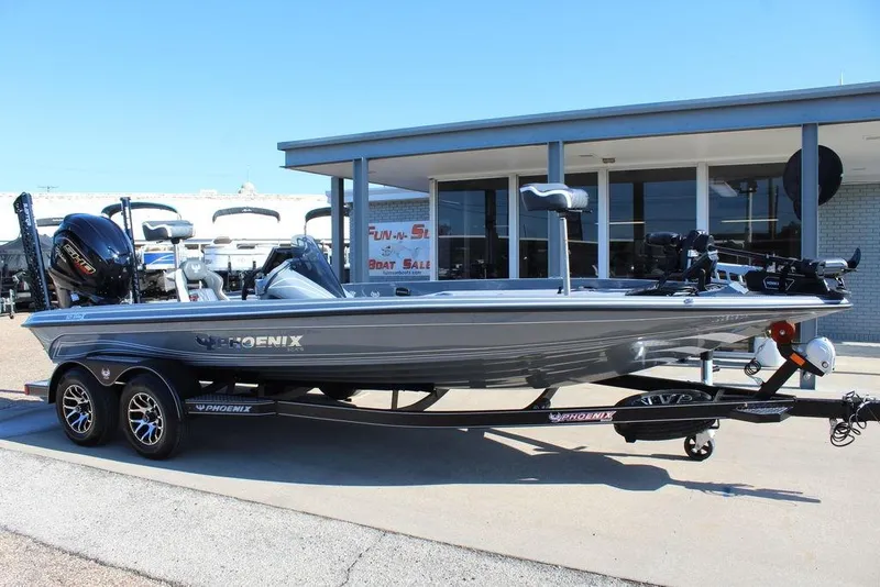 Slide: The Image of 2026 Phoenix 921 ELITE boat on trailer outside dealership, showcasing sleek design and modern features. - 3