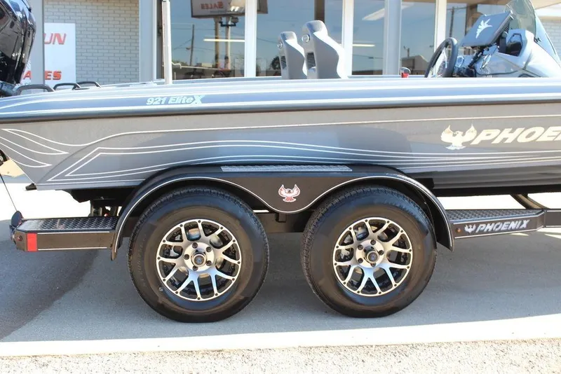 Slide: The Image of 2026 Phoenix 921 ELITE boat on trailer, showcasing sleek design and dual wheels. - 5