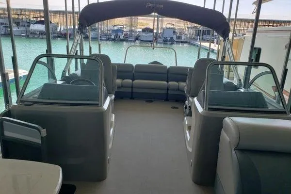 Slide: The Image of 2014 Premier Yachts 250 S-Series RF interior with seating, docked at marina. - 12