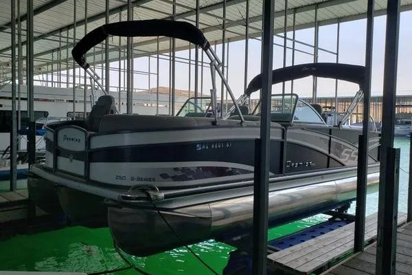 Slide: The Image of 2014 Premier Yachts 250 S-Series RF pontoon boat docked in a covered marina. - 17