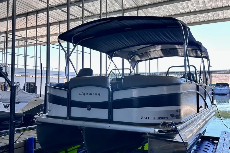 Slide: The Image of 2014 Premier Yachts 250 S-Series RF pontoon boat docked under a covered marina. - 18