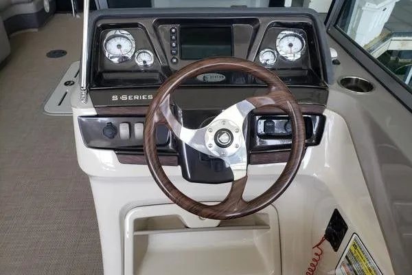 Slide: The Image of 2014 Premier Yachts 250 S-Series RF dashboard with wood-accented steering wheel and gauges. - 5