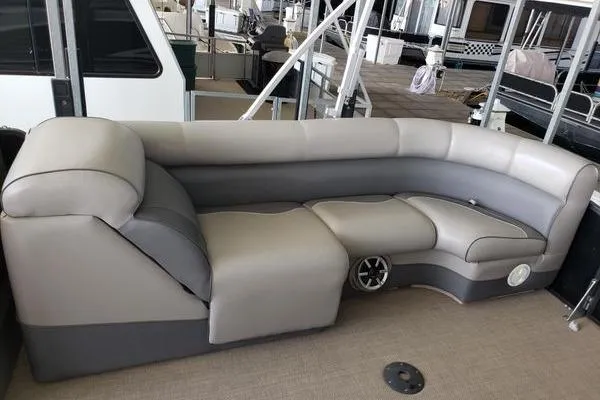 Slide: The Image of Luxurious seating on 2014 Premier Yachts 250 S-Series RF, featuring plush gray upholstery. - 7