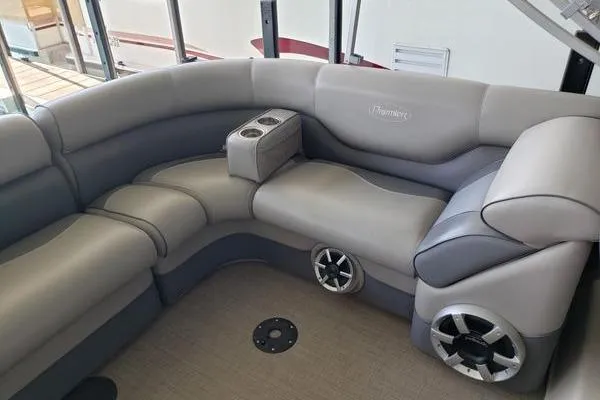 Slide: The Image of Luxurious seating in 2014 Premier Yachts 250 S-Series RF boat, featuring cup holders and speakers. - 9
