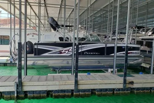 The Image of 2014 Premier Yachts 250 S-Series RF pontoon boat docked in a covered marina. - 0