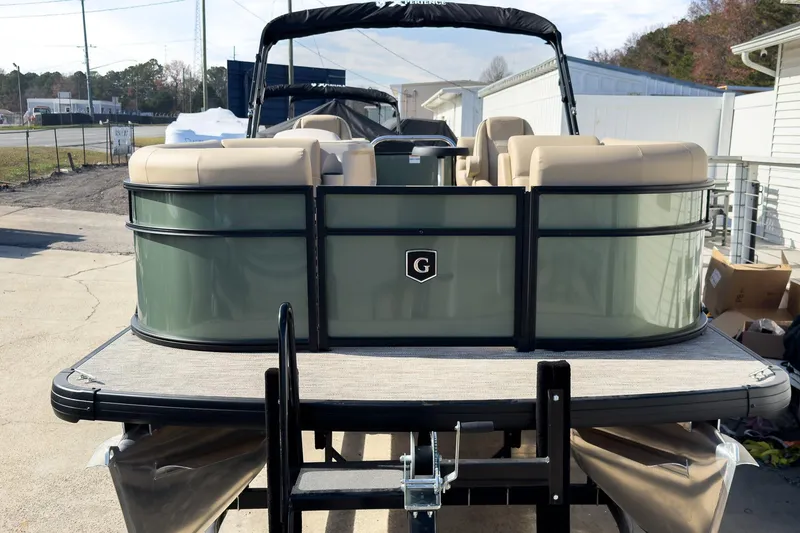 Slide: The Image of 2026 Godfrey Sweetwater Xperience 22' Split Bench Pontoon, green exterior, parked on trailer. - 3