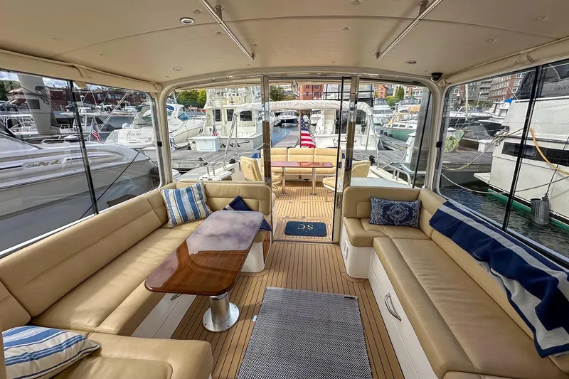 Slide: The Image of Luxurious interior of 2017 MJM 50z yacht with beige seating and marina view. - 14