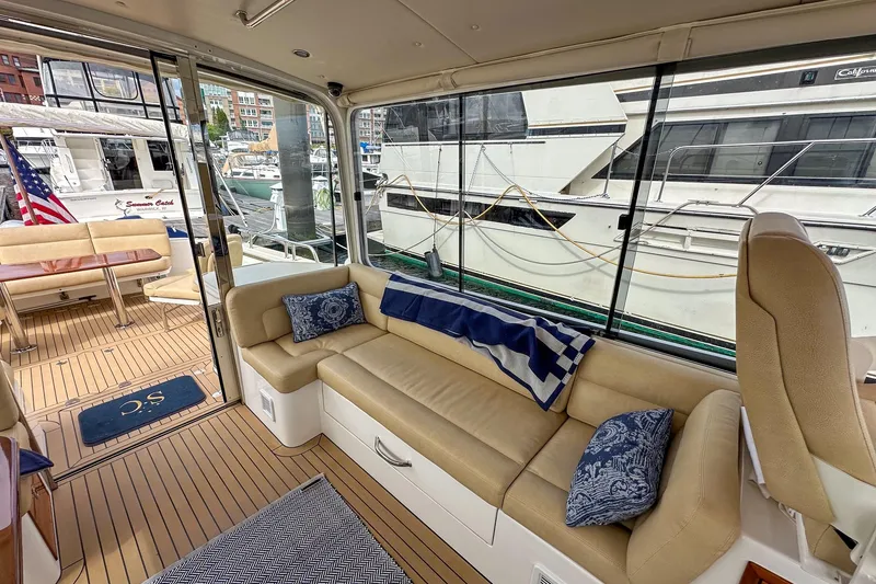 Slide: The Image of Luxurious 2017 MJM 50z yacht interior with beige seating and nautical decor. - 16