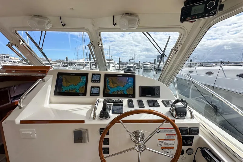 Slide: The Image of Cockpit of 2017 MJM 50z yacht with navigation screens and steering wheel, docked at marina. - 17