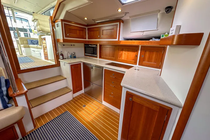 Slide: The Image of Luxurious 2017 MJM 50z yacht interior with modern kitchen and wooden cabinetry. - 22