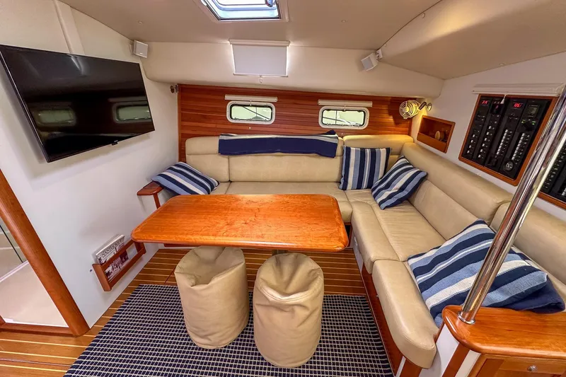 Slide: The Image of Luxurious 2017 MJM 50z yacht interior with plush seating, wooden table, and modern amenities. - 23