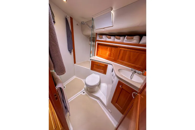 Slide: The Image of Luxurious 2017 MJM 50z yacht bathroom with wood cabinetry and modern fixtures. - 24