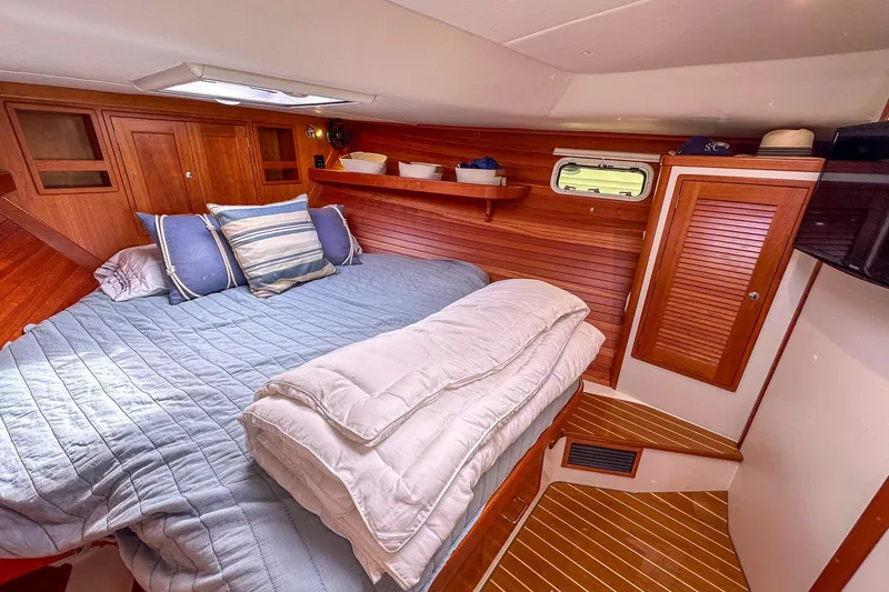 Slide: The Image of Luxurious 2017 MJM 50z yacht cabin with cozy bedding and elegant wood paneling. - 25