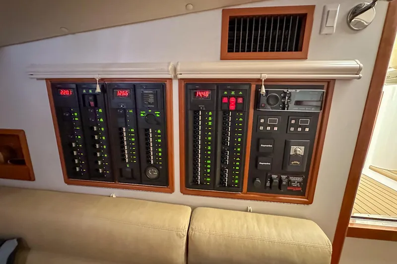 Slide: The Image of Electrical control panel inside a 2017 MJM 50z yacht, featuring various switches and displays. - 29