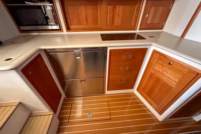 Slide: The Image of 2017 MJM 50z yacht kitchen with wooden cabinets and stainless steel appliances. - 30