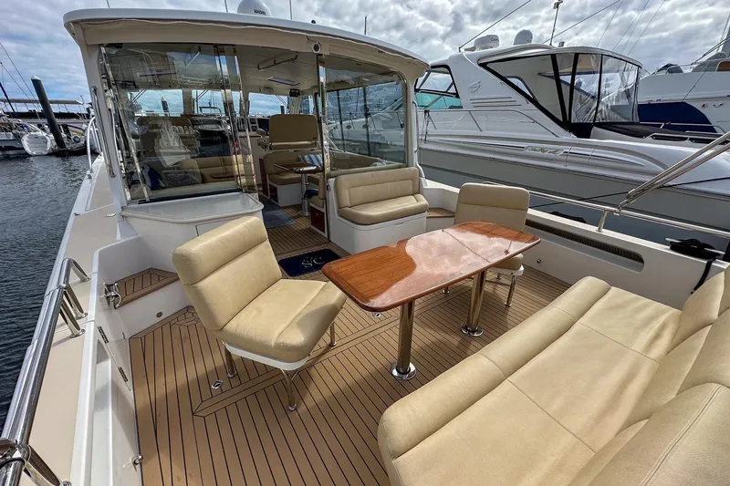Slide: The Image of Luxurious 2017 MJM 50z yacht interior with elegant seating and wooden table at marina. - 7