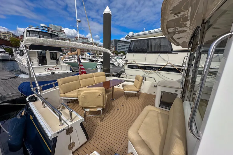 Slide: The Image of Luxurious 2017 MJM 50z yacht docked, featuring spacious outdoor seating and elegant design. - 8