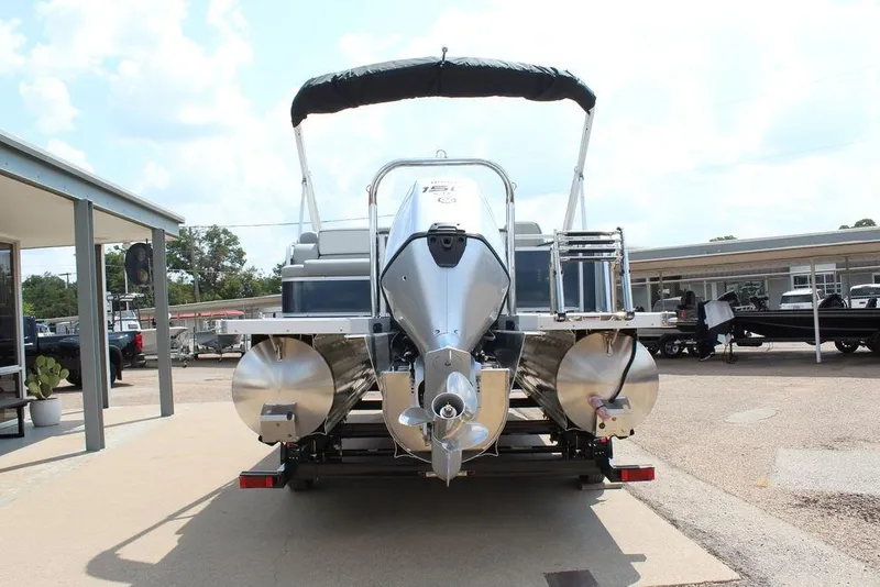 Slide: The Image of 2026 Avalon LSZ Cruiser Rear Bench 23 pontoon boat, rear view, on trailer. - 5