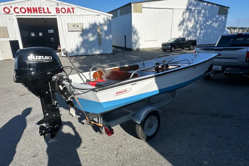 Slide: The Image of 1972 Boston Whaler 13 Super Sport boat with Suzuki motor on trailer outside O'Connell Boat shop. - 3