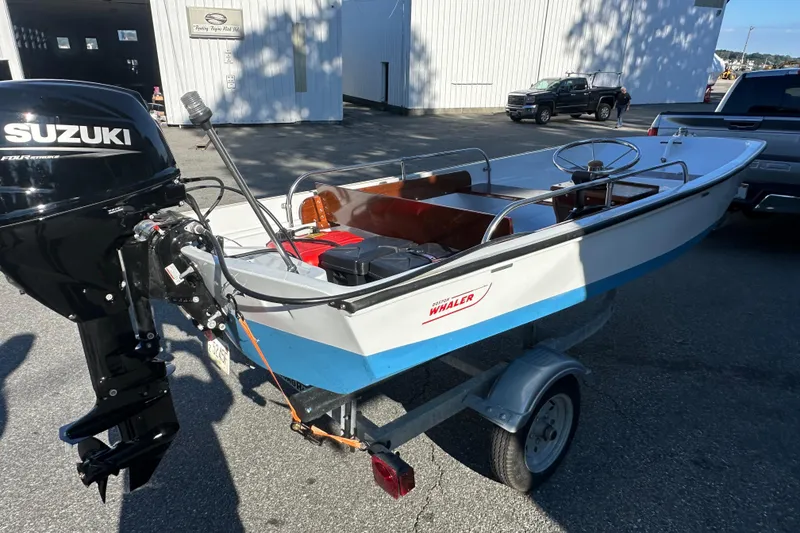 Slide: The Image of 1972 Boston Whaler 13 Super Sport boat with Suzuki outboard motor on a trailer. - 6