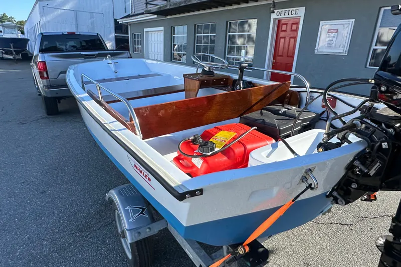 Slide: The Image of 1972 Boston Whaler 13 Super Sport boat on trailer, parked near office building. - 7